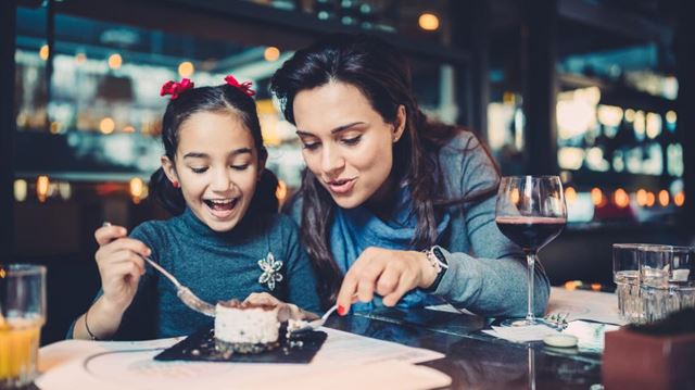 Woman and daughter eating a dessert
